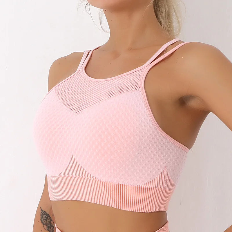 Pink sports bra worn by a person on a plain background